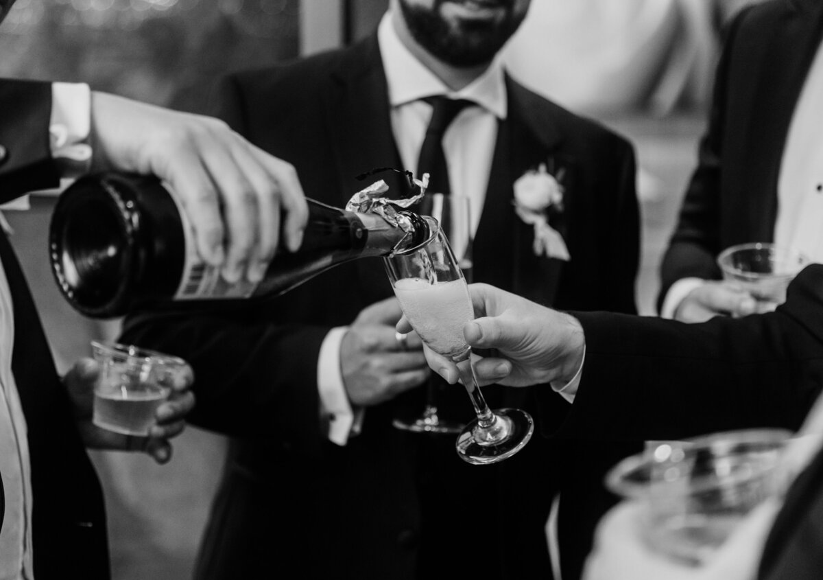 Men pouring champagne