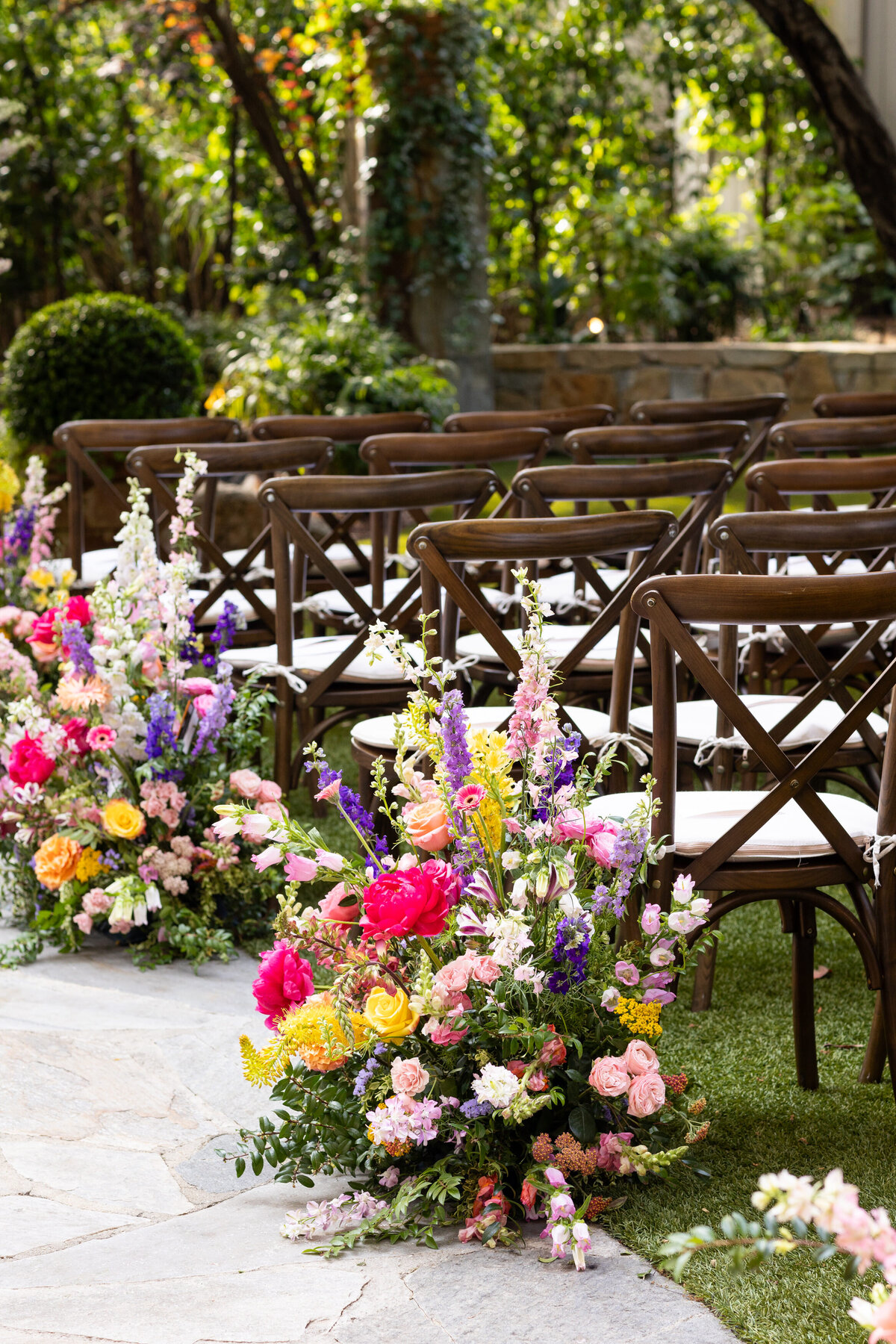 A colorful bouquet of flowers at the end of a row of chairs