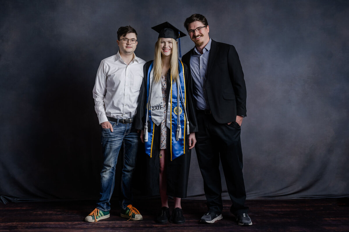 Girl poses with brothers for Prescott family photographer Melissa Byrne