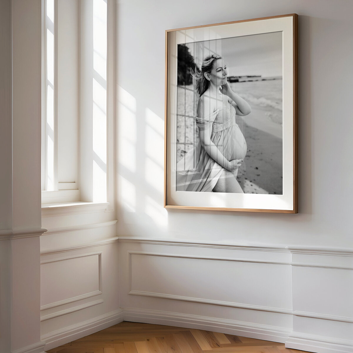 black and white wall art of pregnant mom holding baby bump