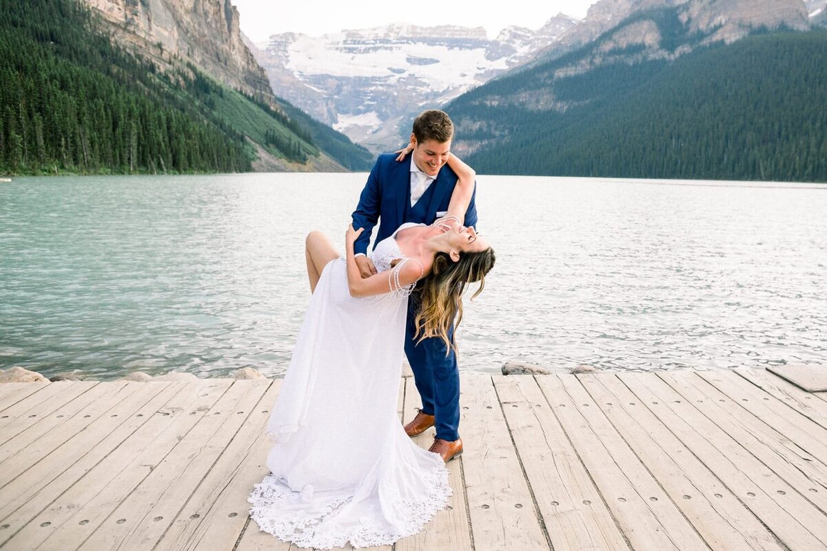 bride-laughing-as-she-bends-backwards-at-Lake-Louise