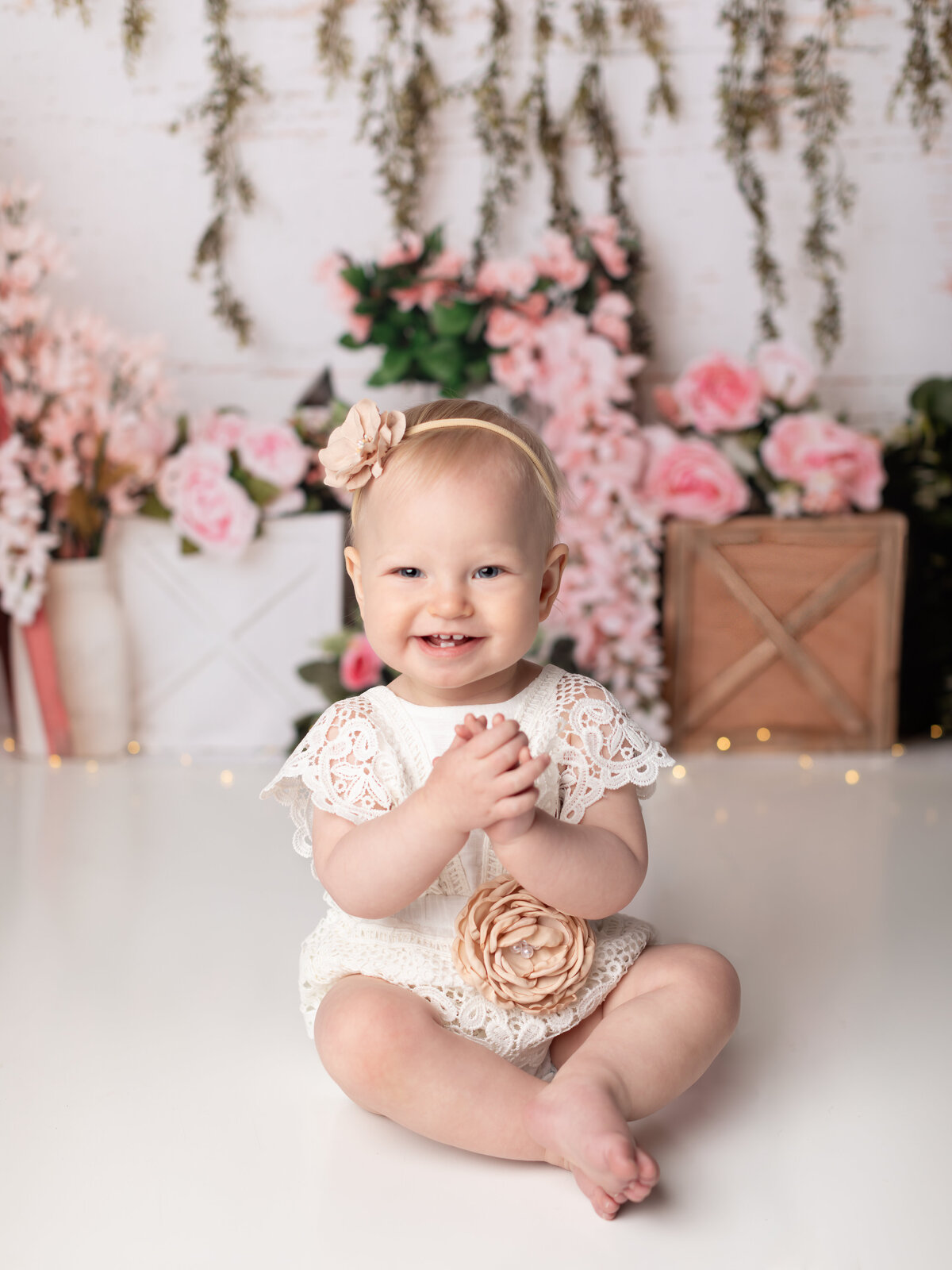 one year old girl birthday photoshoot with floral background