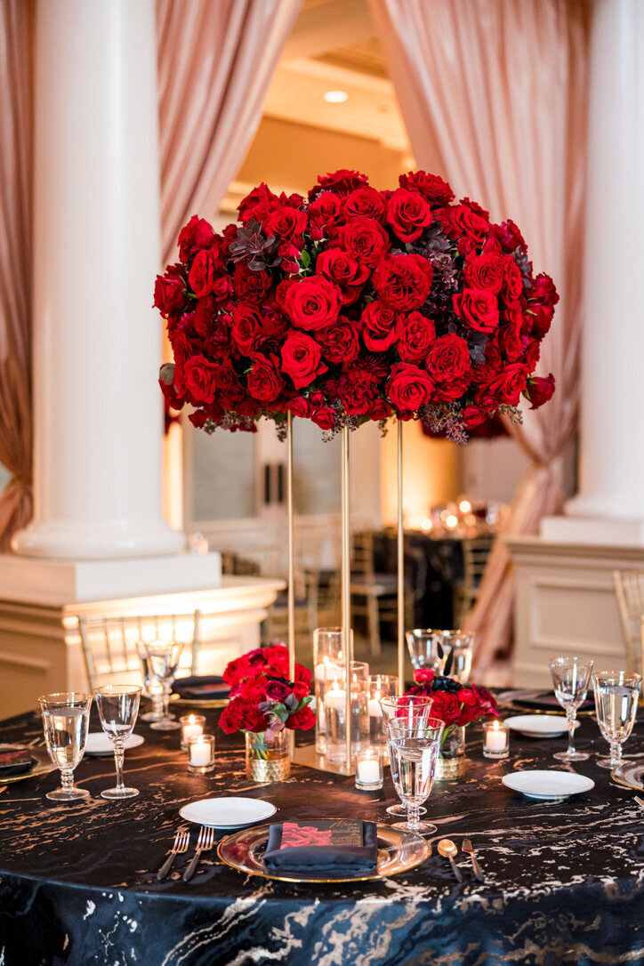 red flowers, gold accents, cocktail arrangements, round tables, formal wedding reception 