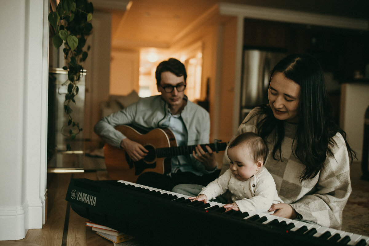 San Francisco family plays music with baby at in home family photography session
