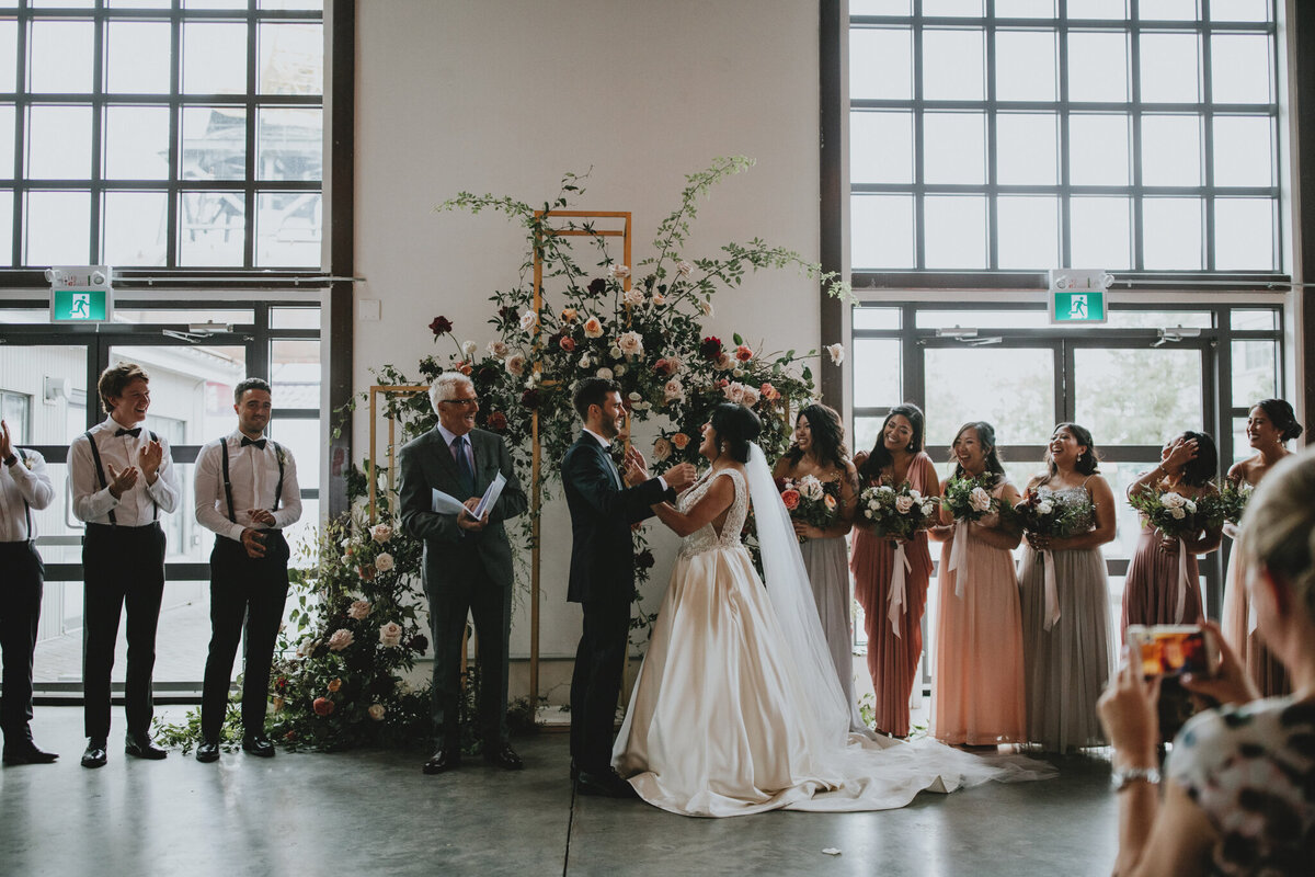 Wedding ceremony at The Pipe Shop Venue, a historic and industrial venue at The Shipyards in North Vancouver, featured on the Brontë Bride Vendor Guide.