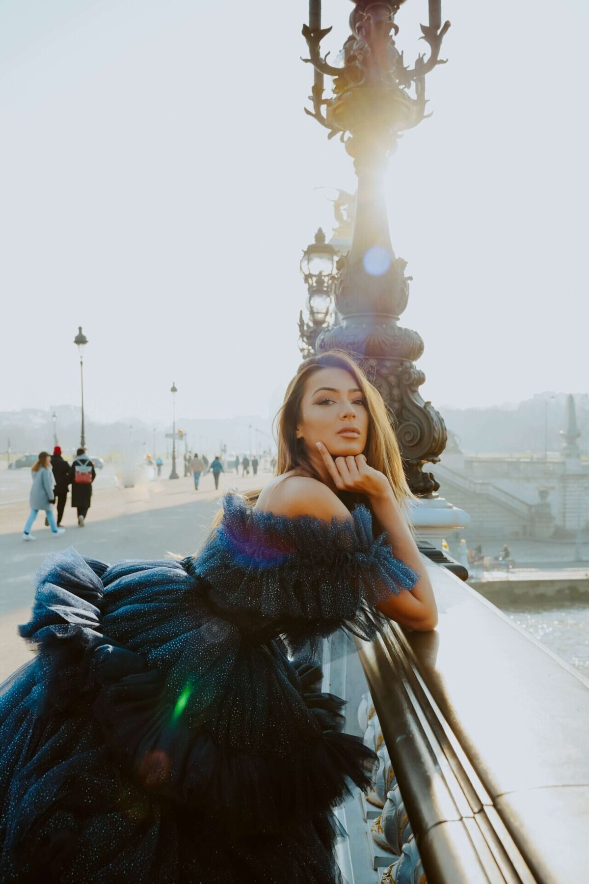 women having a portrait photoshoot in paris wearing a black princess gown