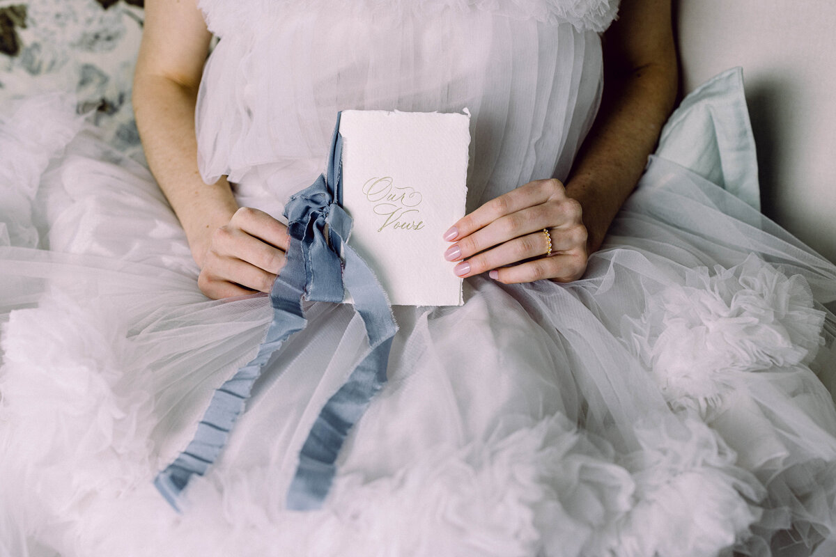 A bride holding her vow book for her New Hampshire wedding