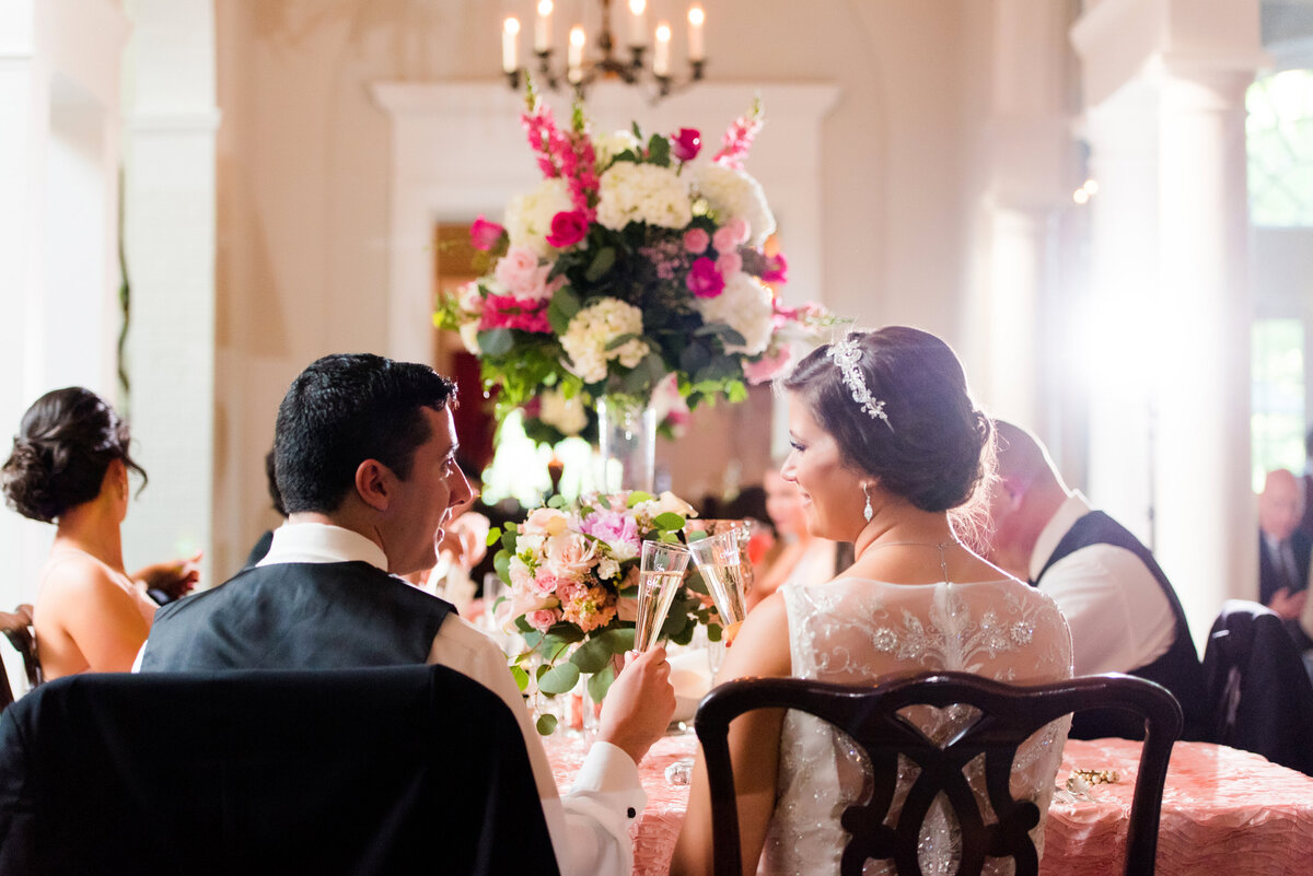 bride and groom toast to each other during their wedding reception at fox chapel golf club
