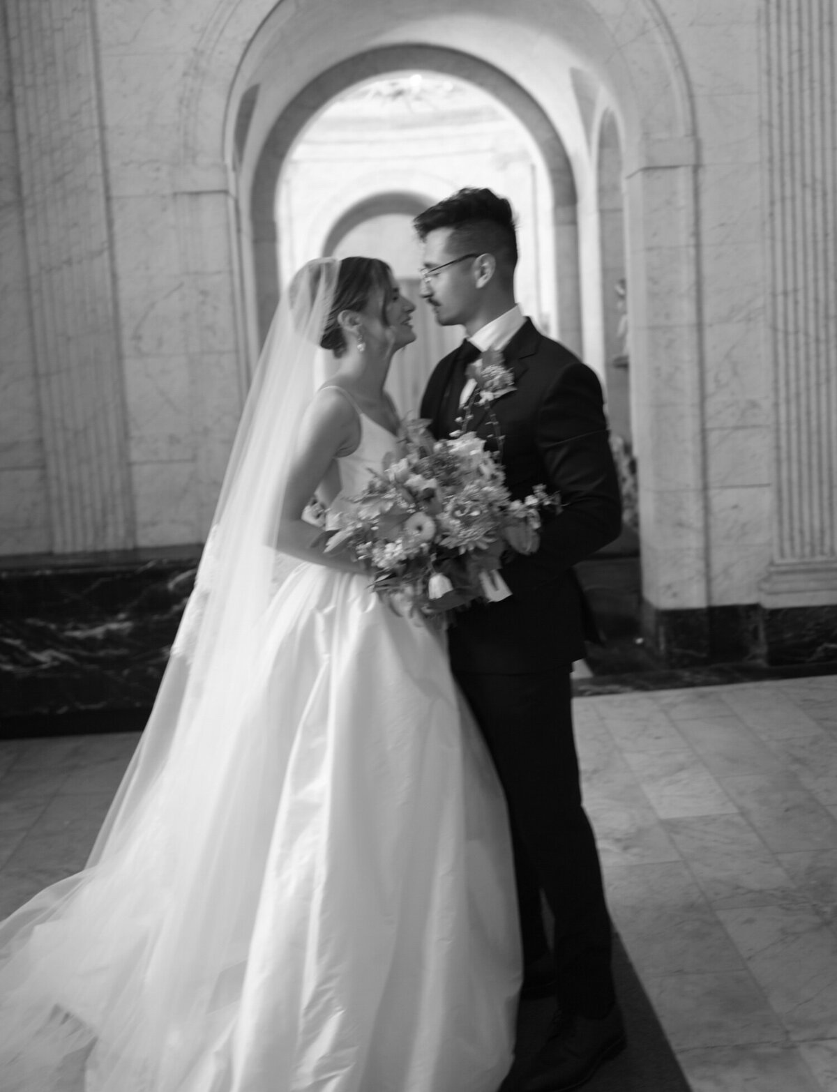 a couple embraces under arches, beautiful architecture of Detroit church St. Peter and Paul