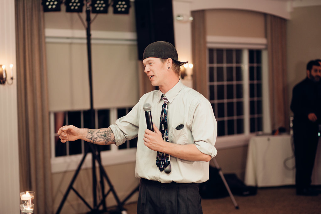Wedding Photograph Of Man In White Long Sleeves And Black Cup Holding a Microphone Los Angeles