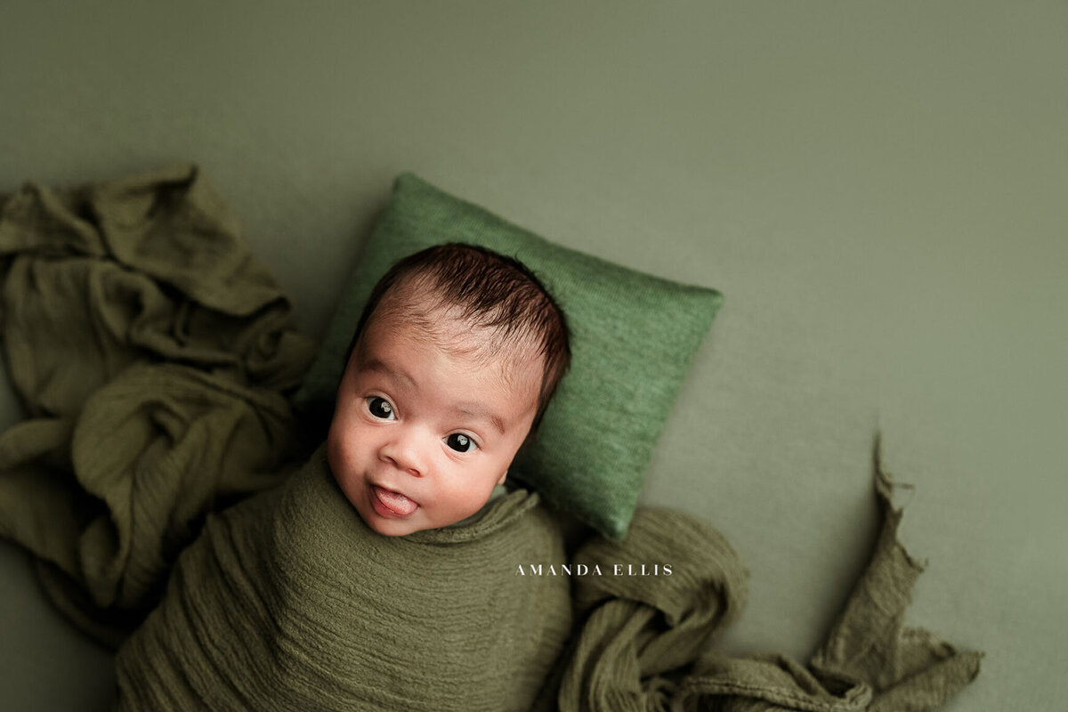 Newborn portrait in luxurious green newborn set