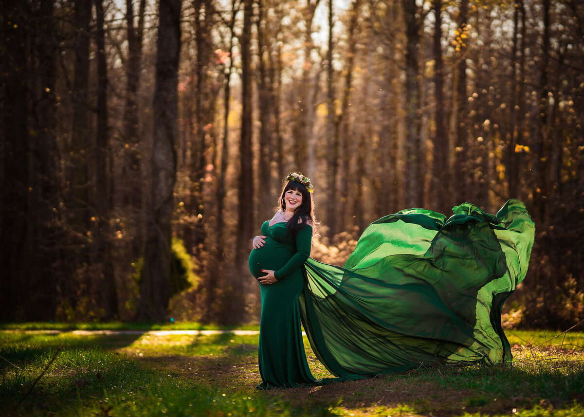 woman maternity green dress woods