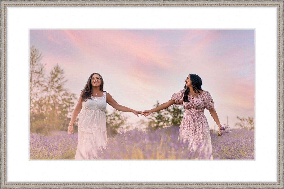 Tacoma mom and daughter holding hands at lavender farm in Auburn with sunset skies behind them smiling in cottage-core clothes
