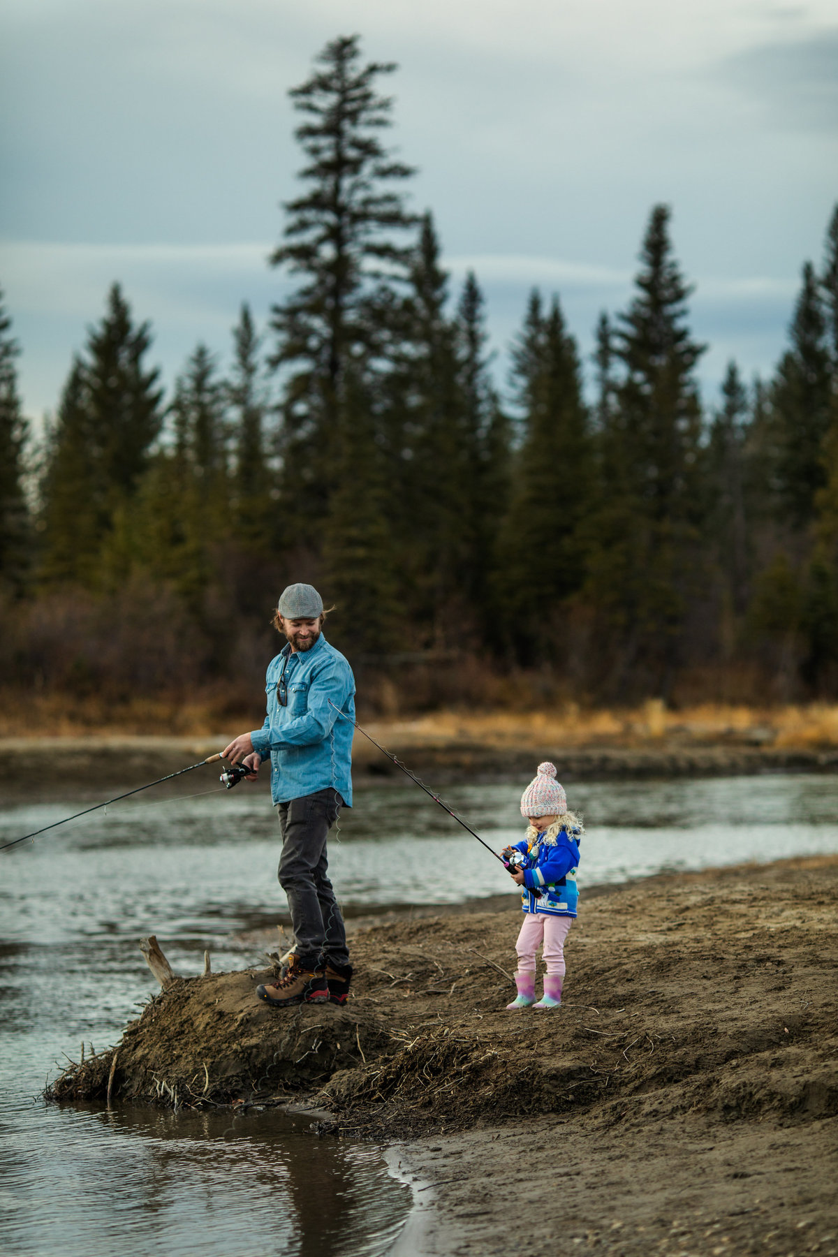 Image of father fishing with young daughter