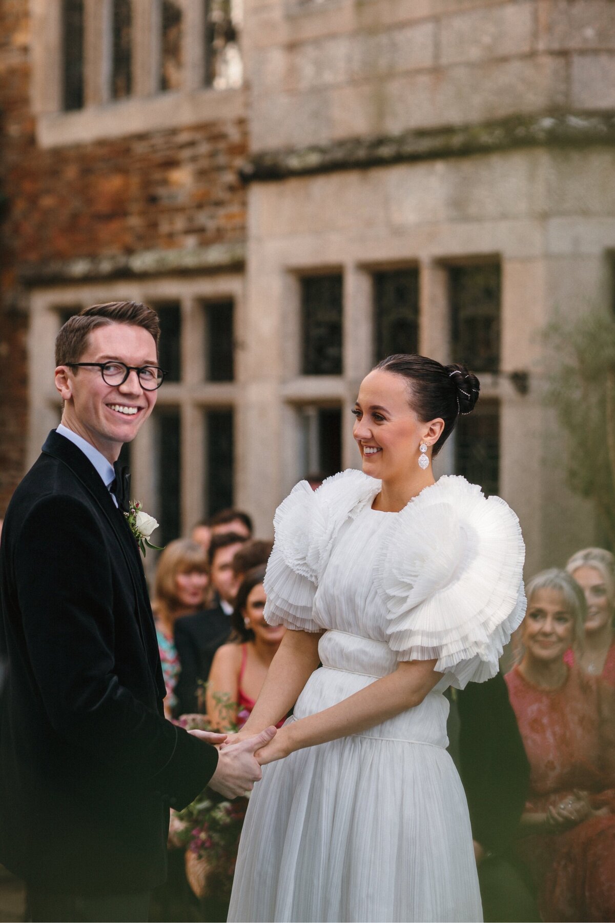 couple smiling during wedding ceremony in Devon