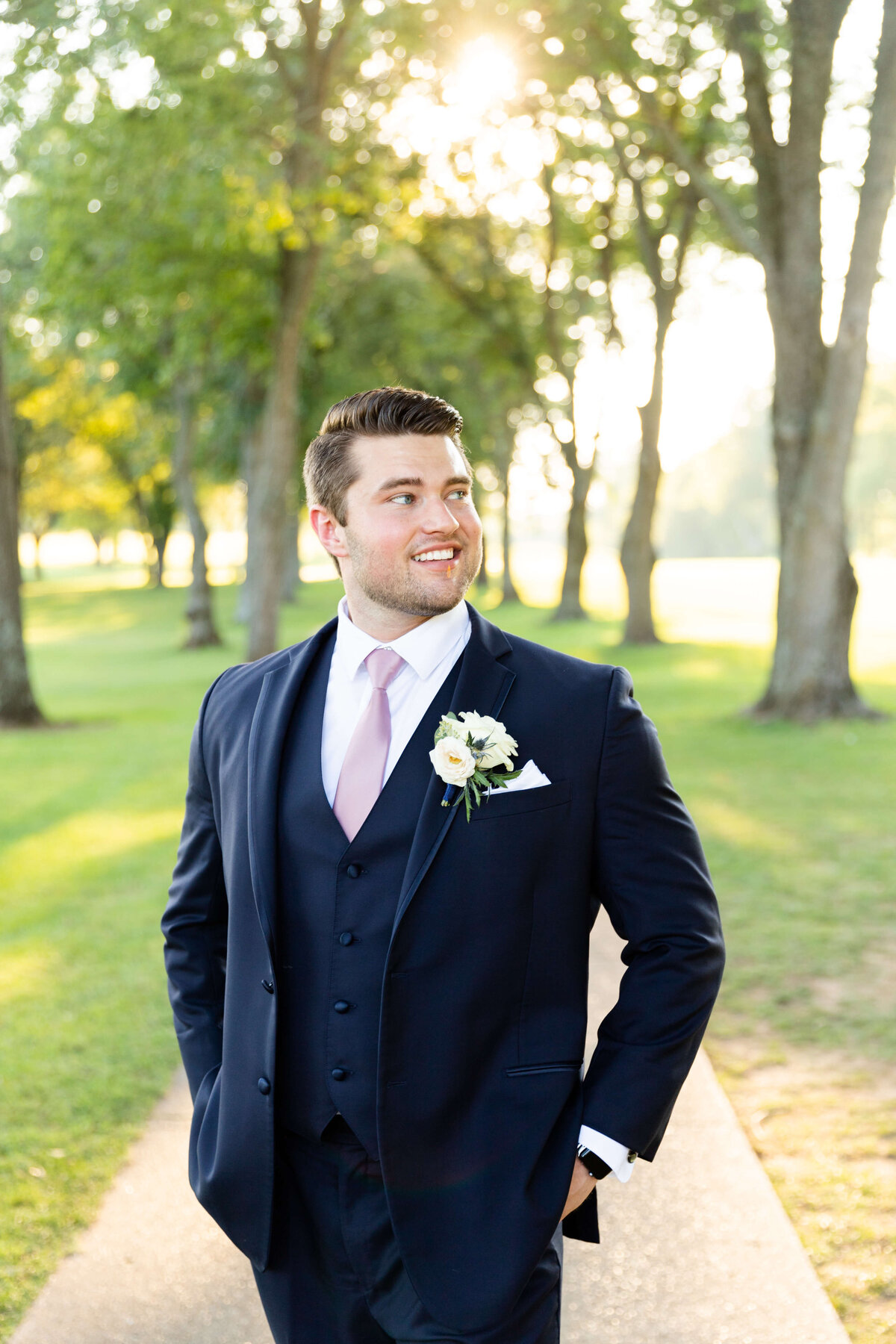 Groom in navy blue suit at wedding at Stones River Country Club