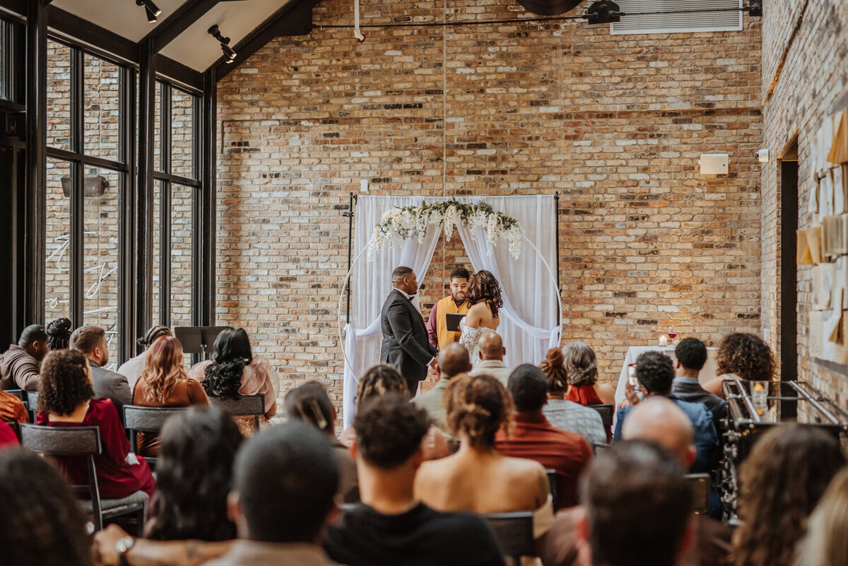 storyteller-collective-photo-co-wedding-ceremony-at-brick-venue-surety-hotel-des-moines-iowa