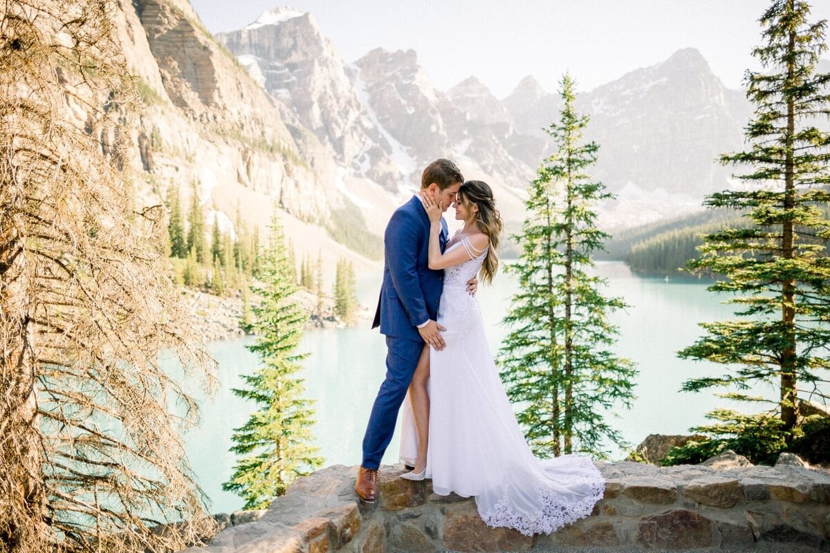 Groom-holding-his-bride-leg-at-Moraine-Lake