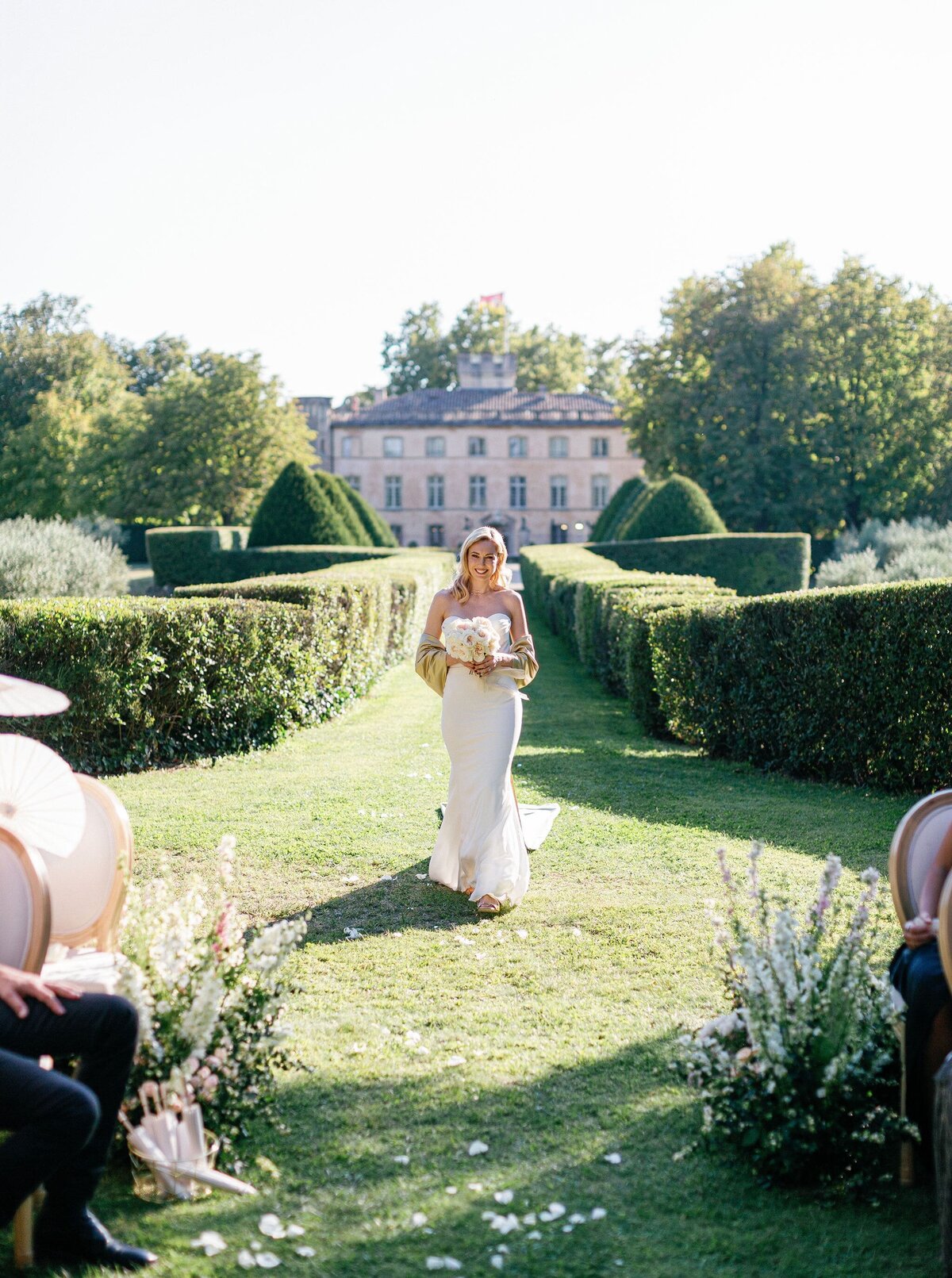 Bride-walking-aisle-chateau-gardens