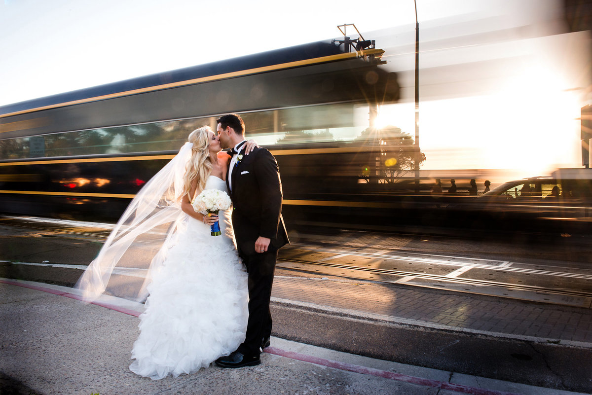 bride and groom by faded train