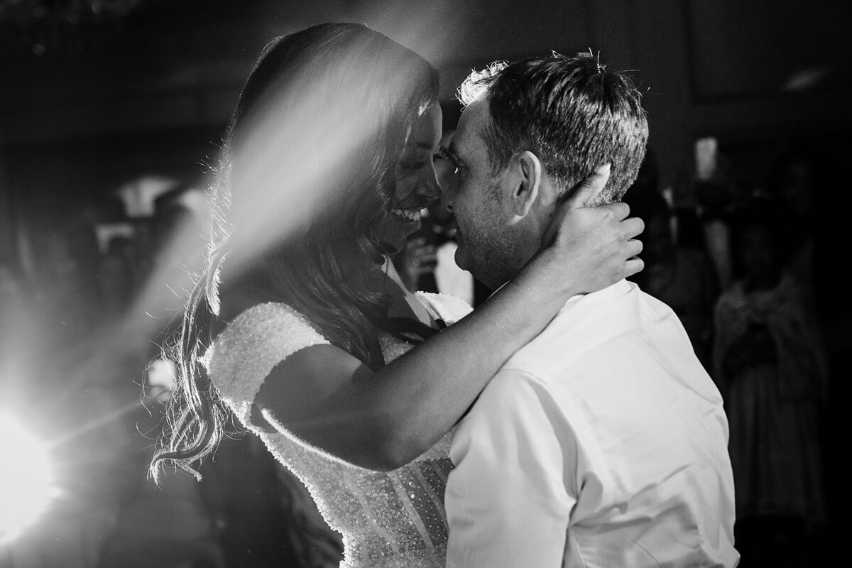 Bride holding her groom's neck pulling in for a kiss at The K Club in Kildare, Ireland