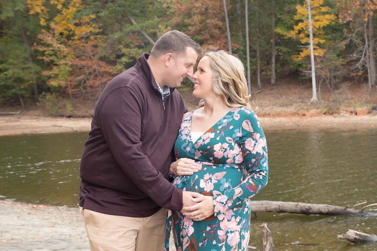 husband and wife by the water expecting their first child Columbia SC