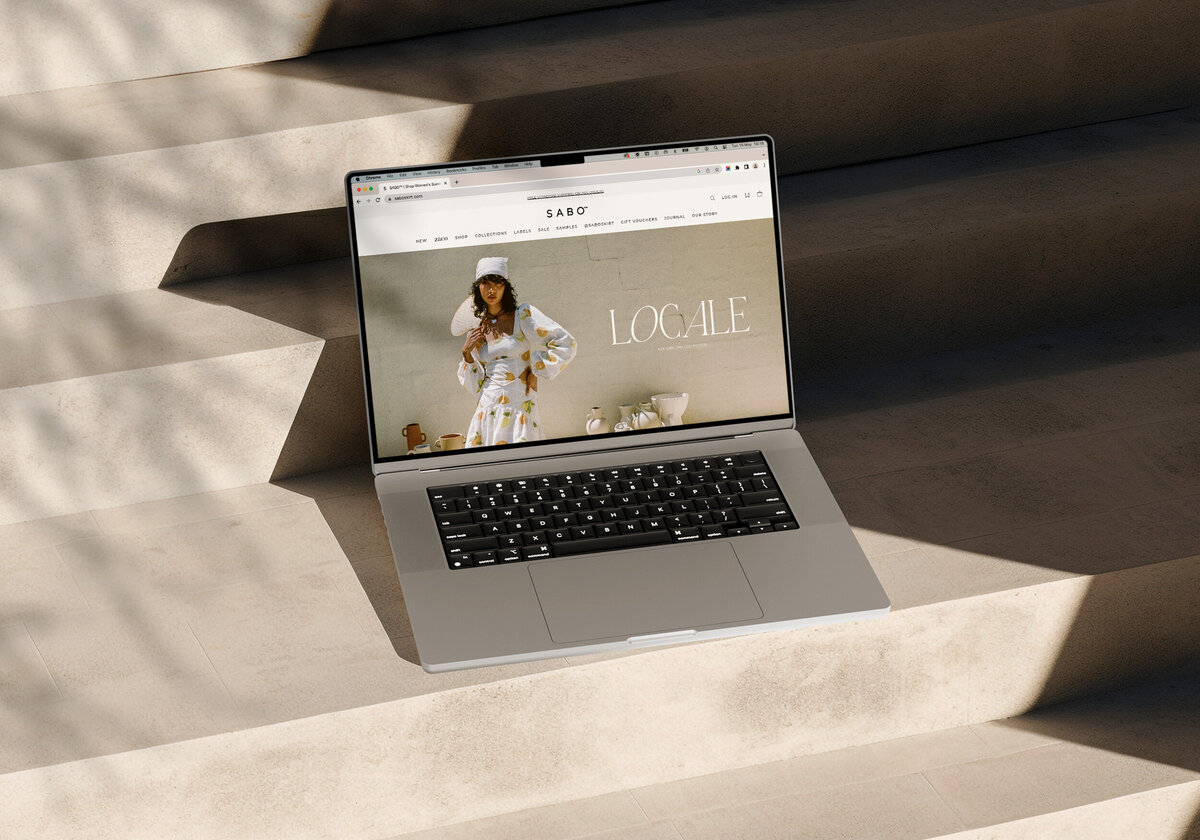 Laptop mock up with Locale homepage design on
