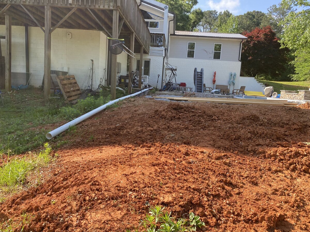 red-dirt-in-backyard-of-white-house