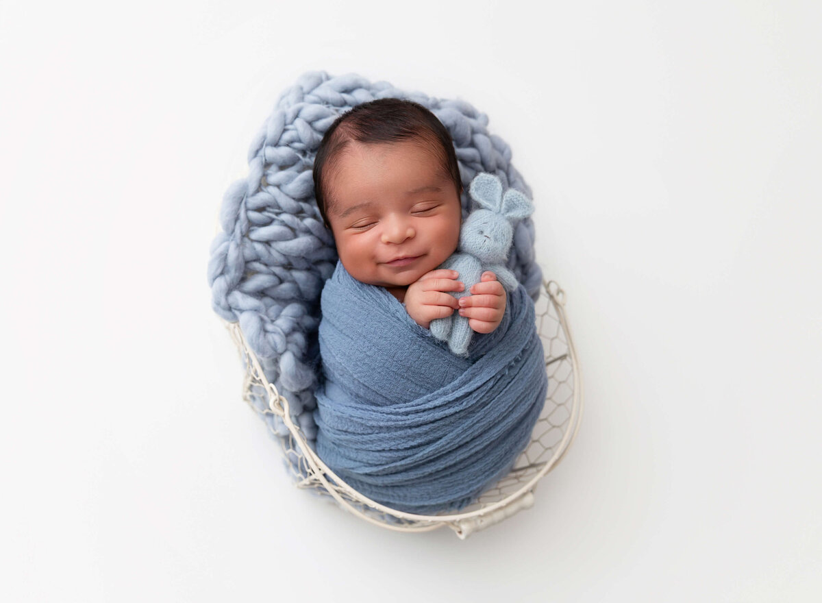 Brooklyn studio newborn photoshoot of baby boy with soft blue tones, captured by NYC newborn photographer