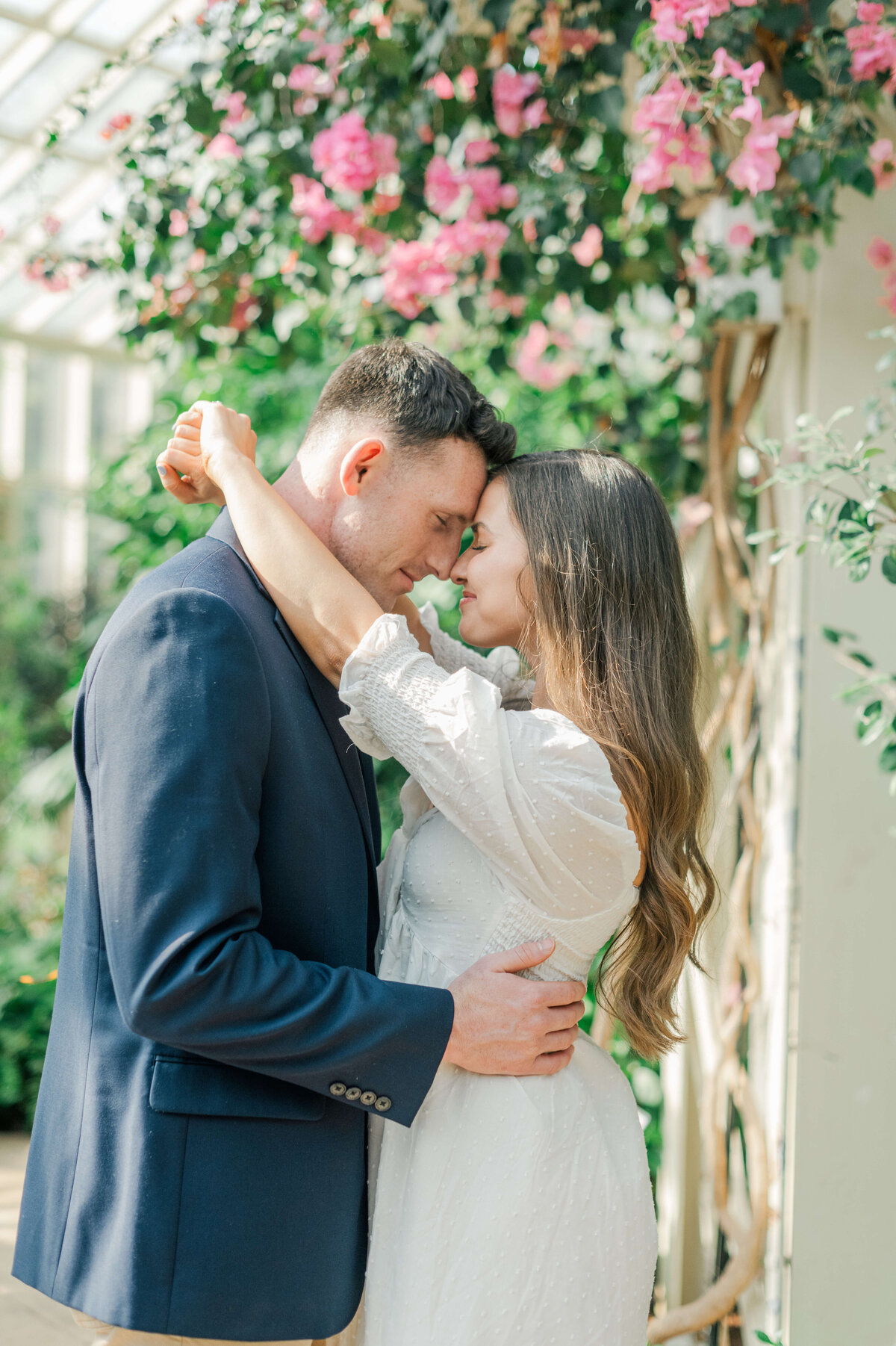 Engaged couple hugging while looking into each others eyes