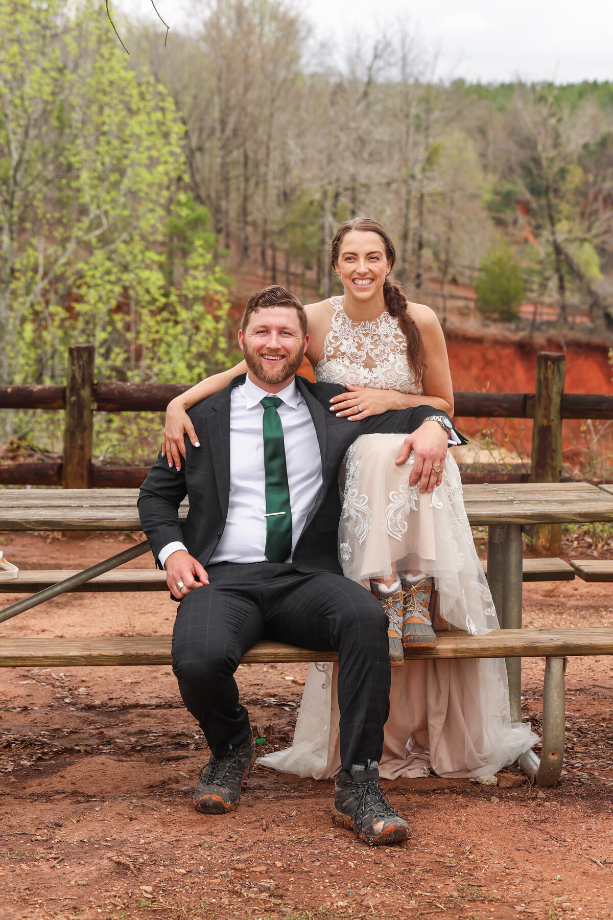 bride and groom sitting at picnic table at an overlook after elopement at Providence Canyon State Park by Columbus Georgia elopement photographer Amanda Richardson Photography