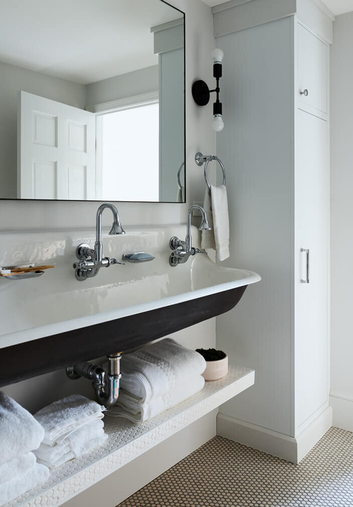 Hingham interior design firm creates updated bathrooms for a historic Hingham home, blending modern elements with classic charm for a functional space.