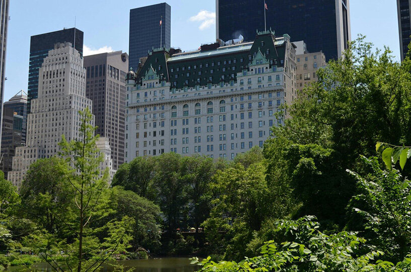 A large building featuring numerous windows reflecting the sunlight.