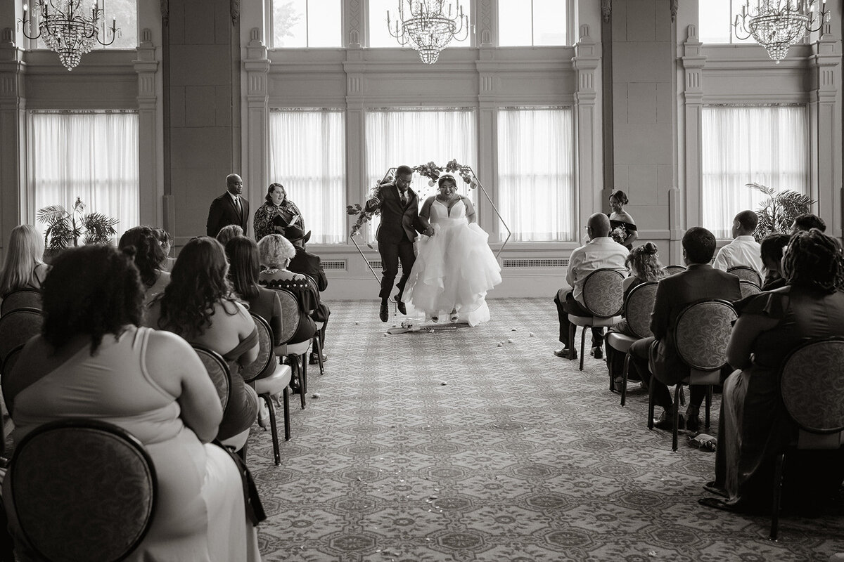 couple jumping the broom wedding ceremony