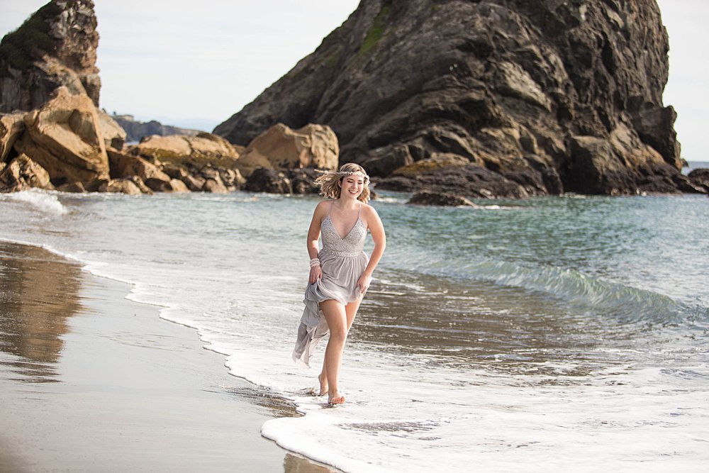 girl running on beach near the ocean waves