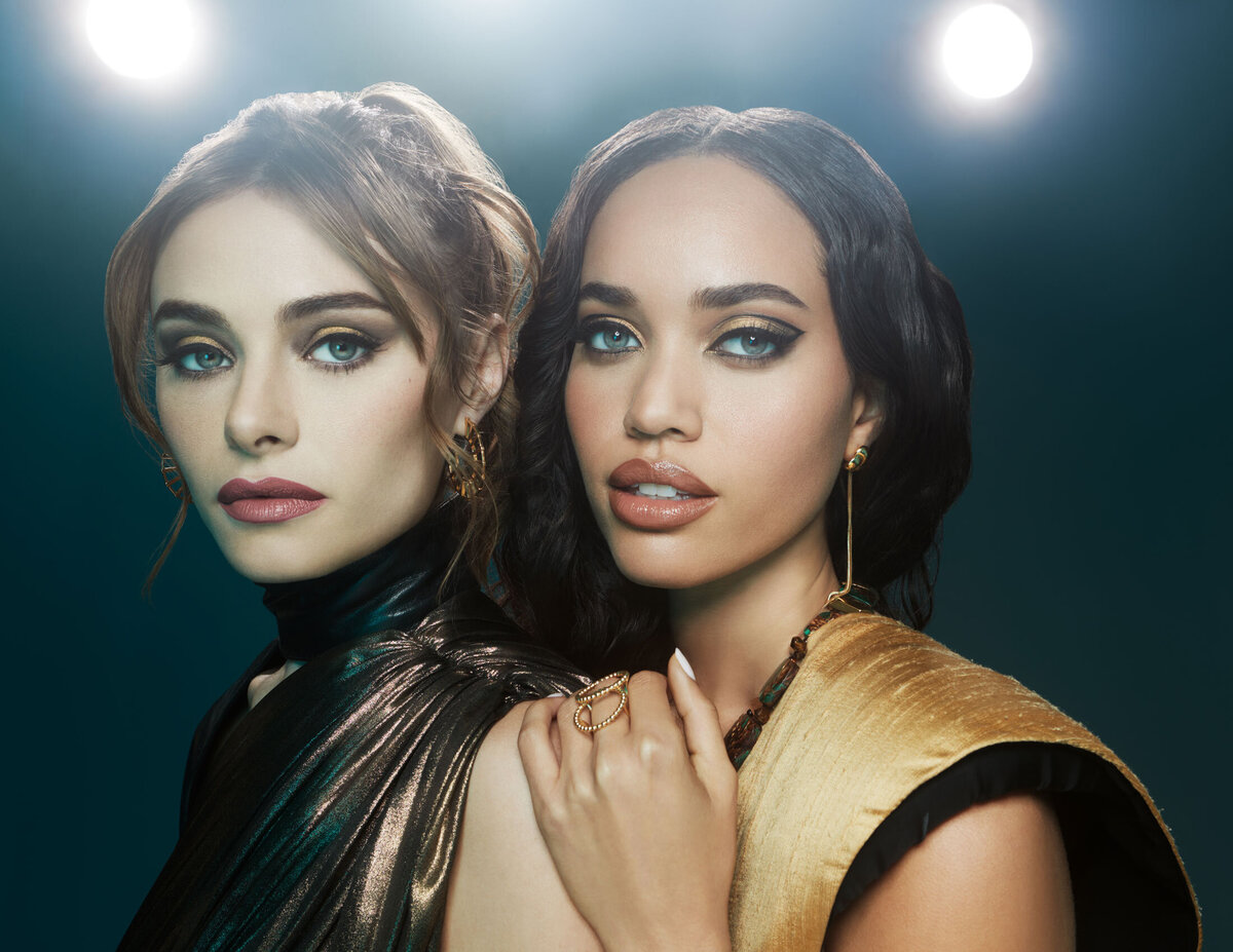 Dual portrait of Gracie and Sena in glamorous lighting, wearing elegant outfits and bold makeup, captured by Ylva Erevall.