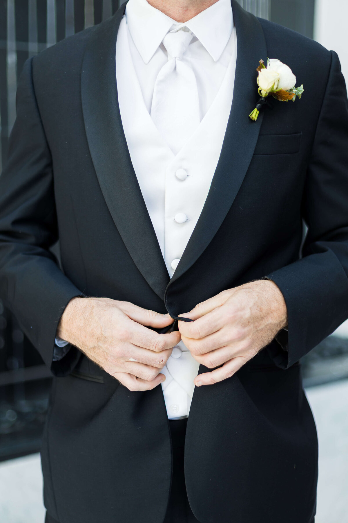 Groom buttoning up suit at The Carrick House Wedding venue in Lexington, KY