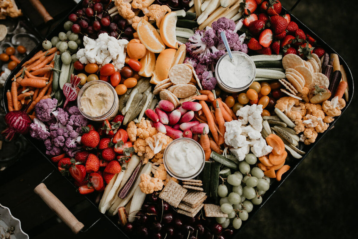 Colourful charcuterie at The Gathered, a nostalgic greenhouse based in Kathryn, Alberta wedding venue, featured on the Brontë Bride Vendor Guide.