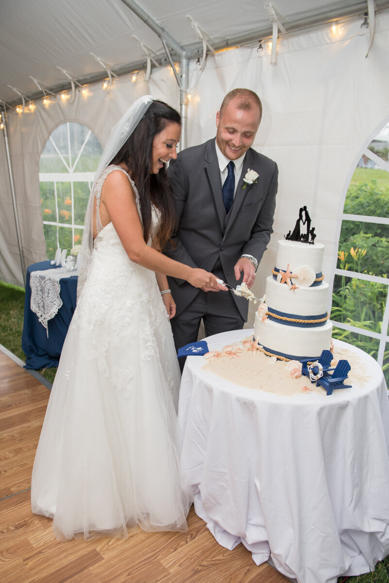 Bride and groom wedding cake cutting