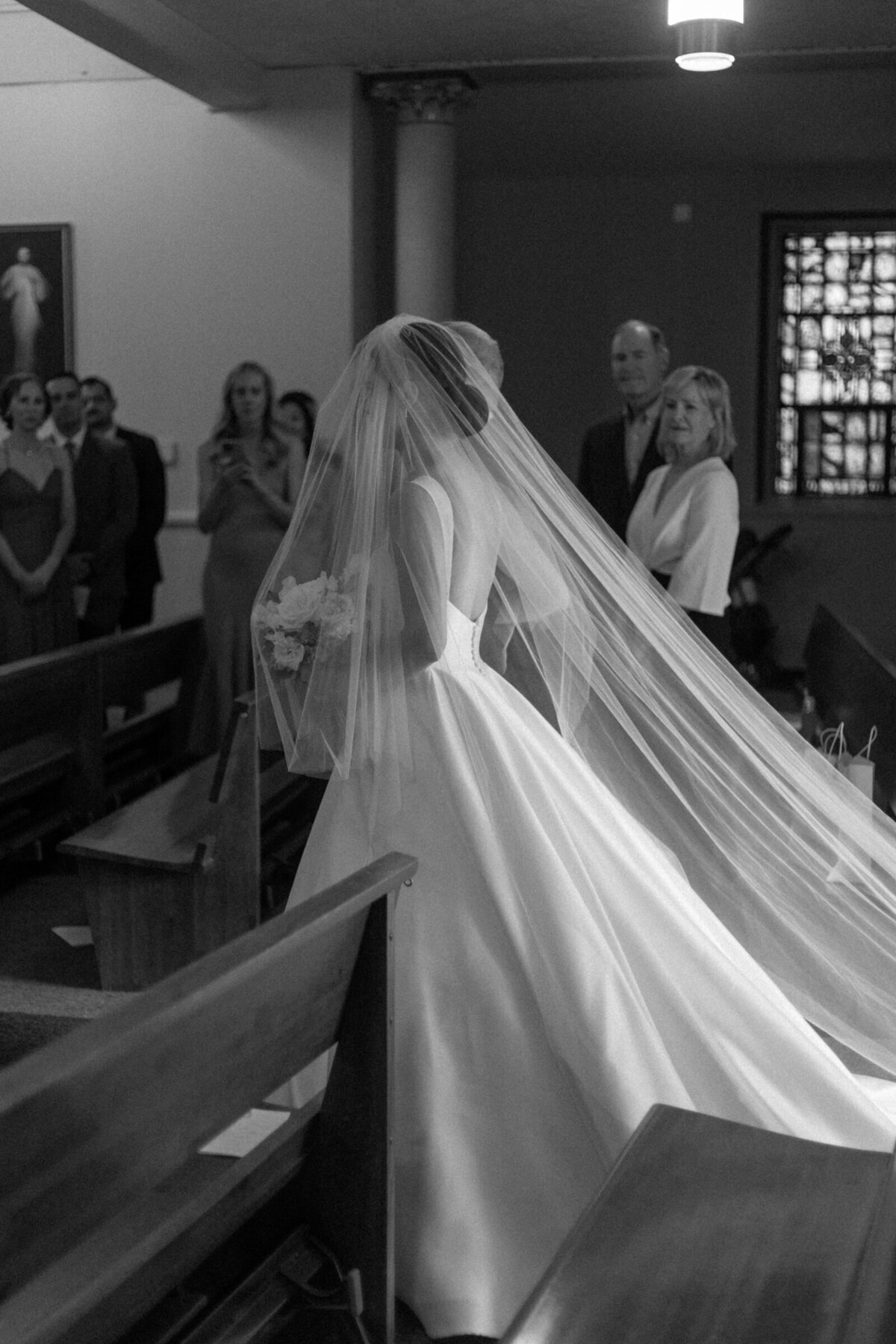 Bride walking down aisle in church by chicago wedding photographer Allison Francois