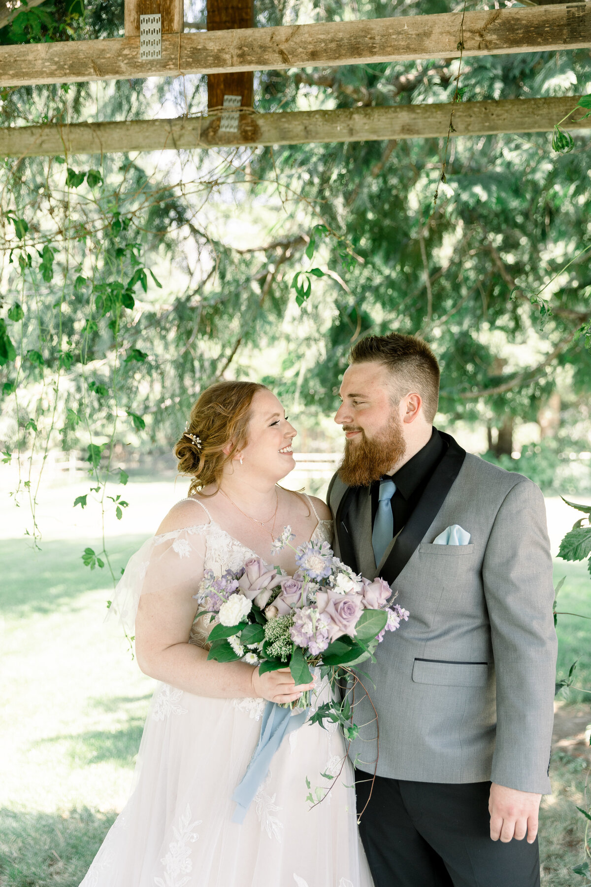 Bride and groom looking at each other and smiling taken by Leavenworth Photographer