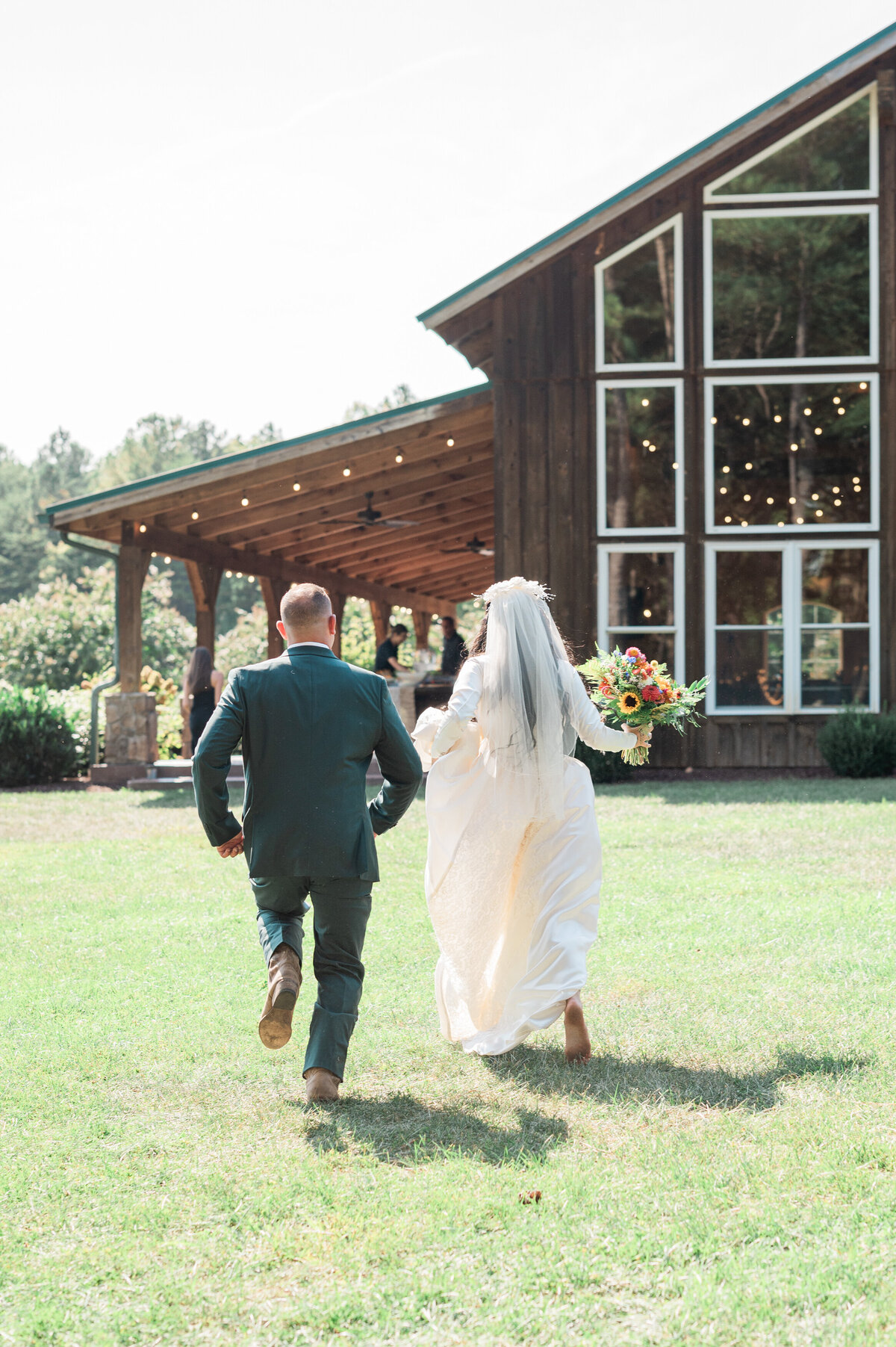 Newlyweds running towards a vintage looking building