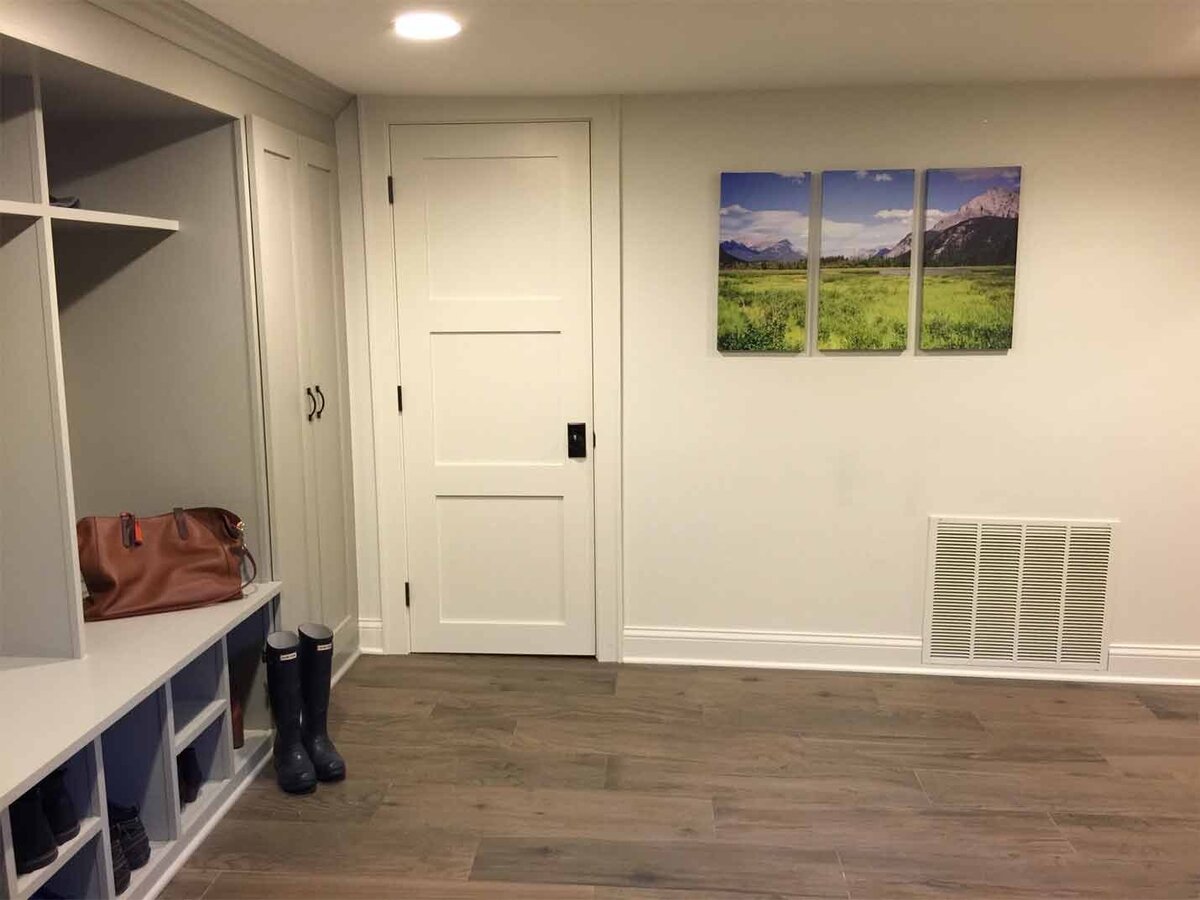 Mudroom design with white built in storage shelves