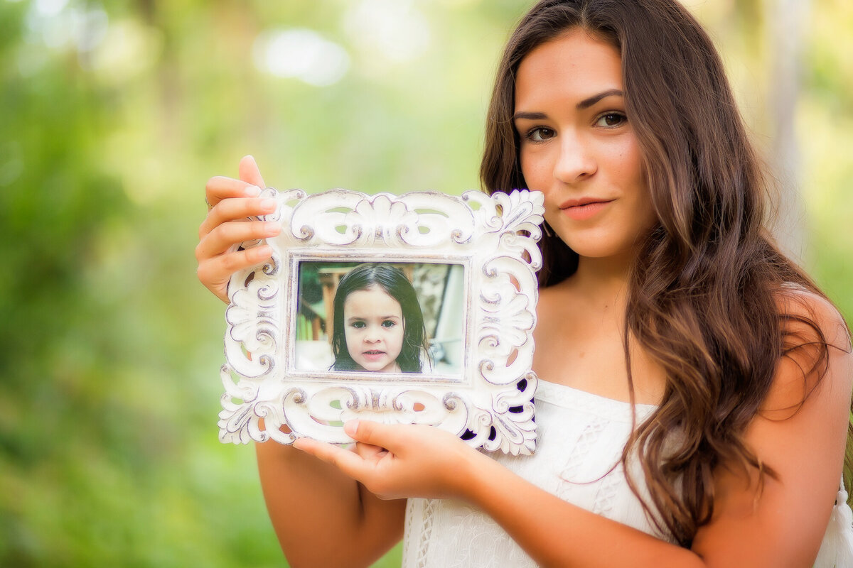 color image of senior girl holding a baby image of herself