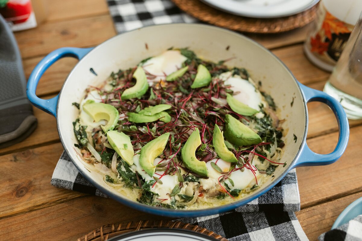breakfast egg dish topped with avocado