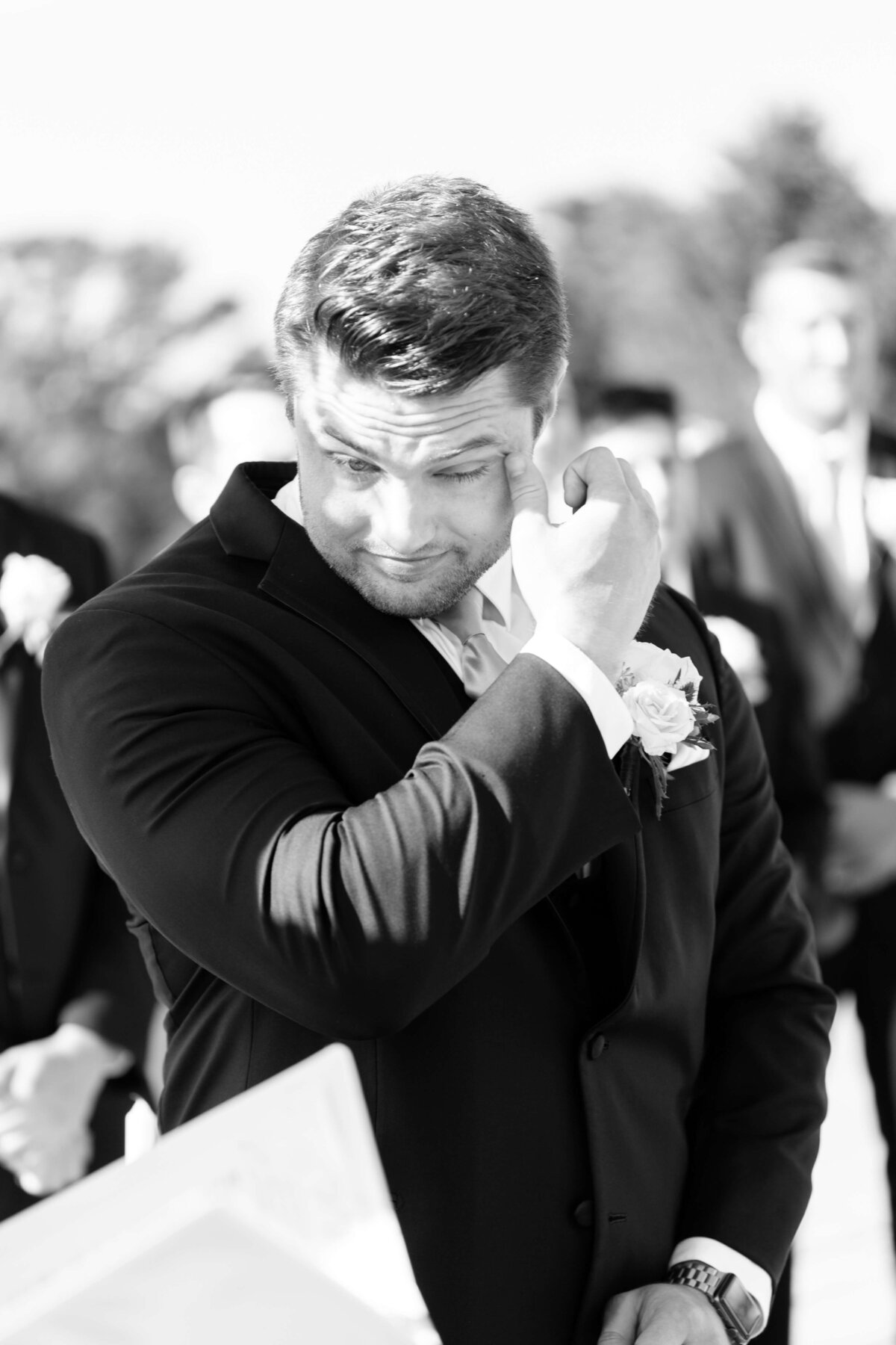 Groom wiping his eye at wedding at Stones River Country Club