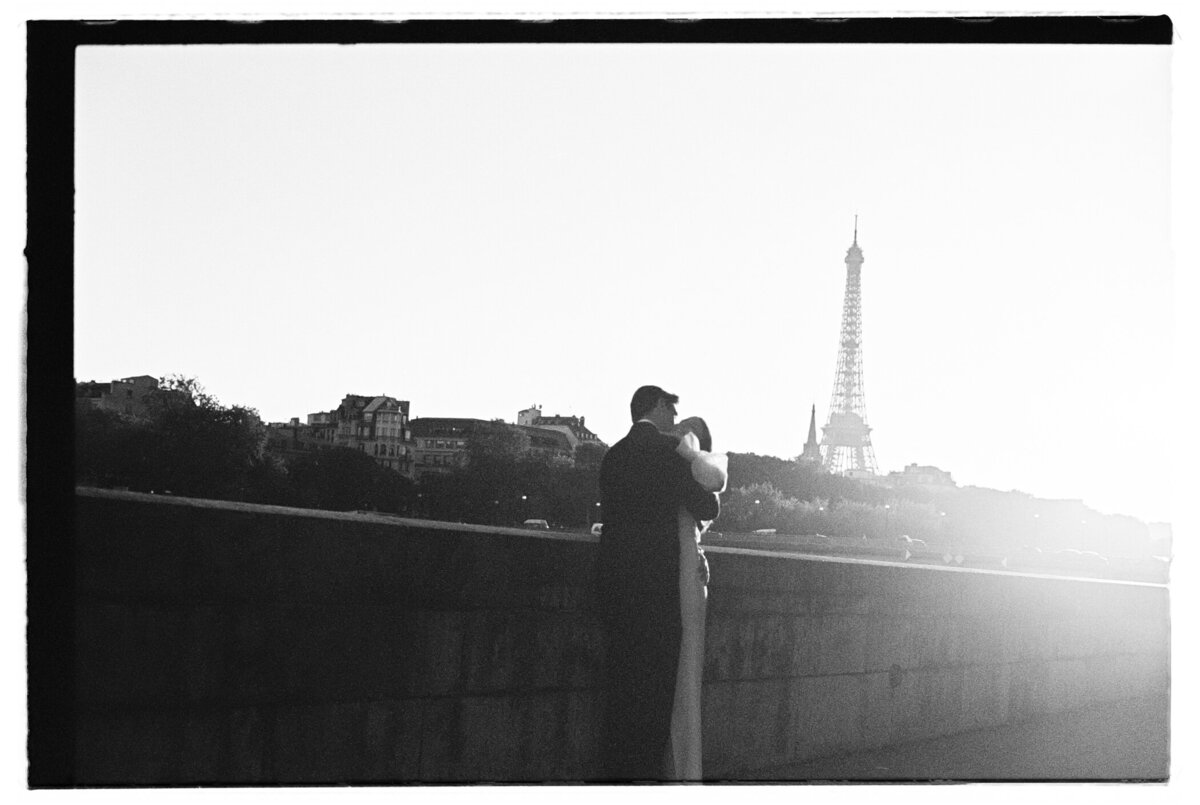 bride and groom hugging in front of Eiffel tower