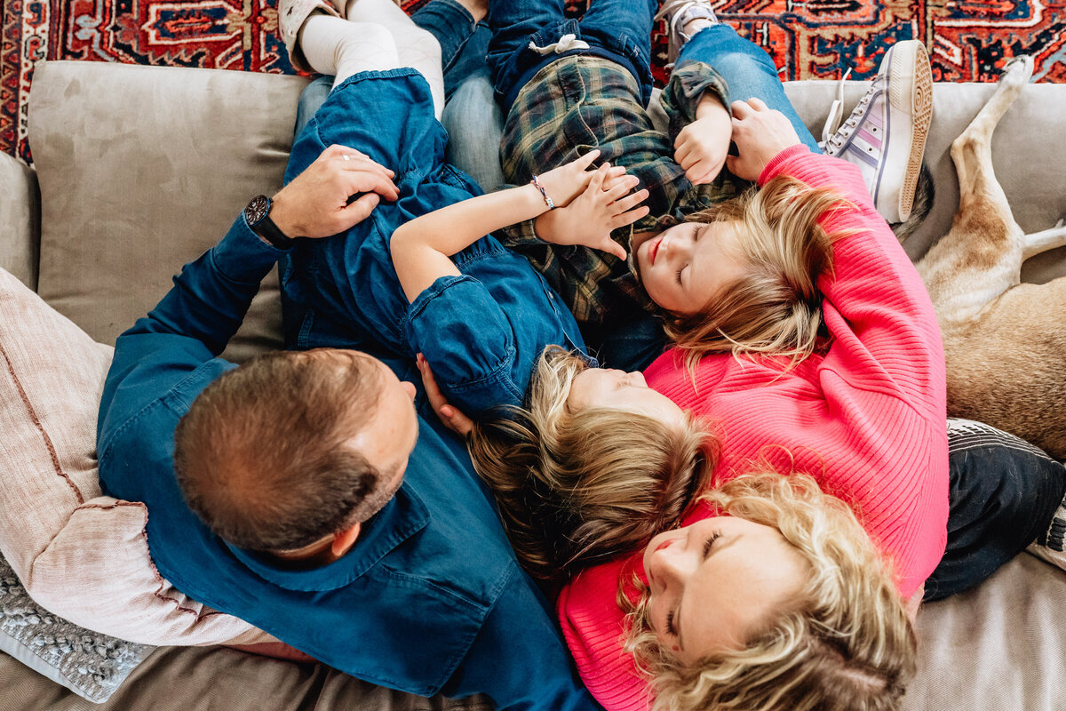 A photo from above of a family of four on a couch.