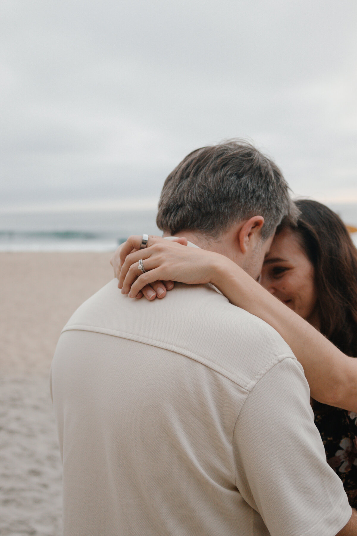 mom and dad intimately look at each other while mom's hands are wrapped around dad's neck