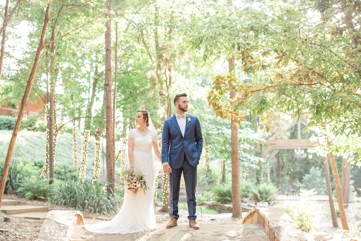 the happy couple look  away from each other at a beautiful location in the woods near Longmont, Colorado